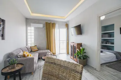 a living room with a couch and chairs and a bed at D&G Lux Flat City View next to Old Town & Market in Chania Town