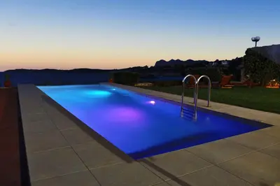a swimming pool with blue lighting at dusk at VILLA NIBA in Kalathas