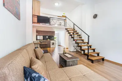 a living room with a couch and a staircase at Neva's Apartment's in Center Chania 1 2 in Chania Town