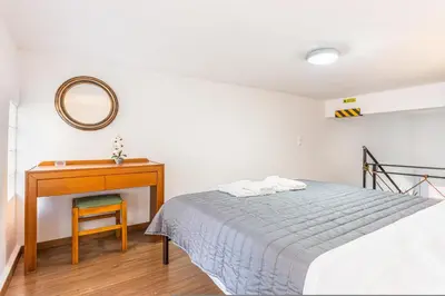 a bedroom with a bed and a desk and a mirror at Neva's Apartment's in Center Chania 1 2 in Chania Town