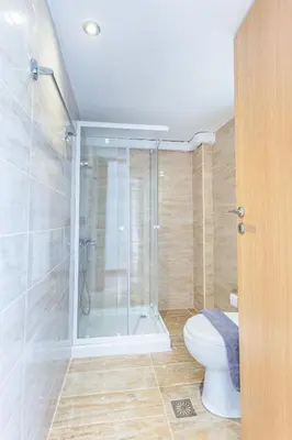 a bathroom with a toilet and a glass shower at Neva's Apartment's in Center Chania 1 2 in Chania Town