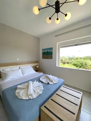 a bedroom with a bed with towels on it at Stelios Studios Sougia in Sougia
