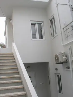 a stairway in a white building with stairs and windows at Sea U in Chania Town