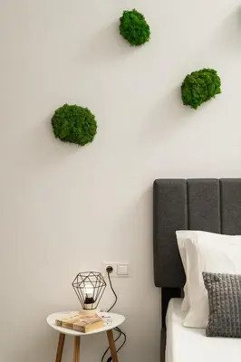 a bedroom with a bed and a table with plants on the wall at Michalis NCHouse 33 in Chania Town
