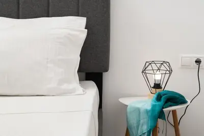 a bedroom with a bed and a table with a lamp at Michalis NCHouse 33 in Chania Town
