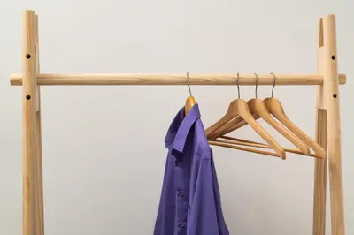 a wooden rack with a blue jacket and hangers at Michalis NCHouse 33 in Chania Town