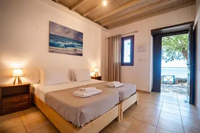 a bedroom with a bed and a view of the ocean at Mylos Seaside Experience in Frangokastello