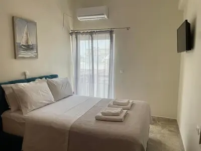 a bedroom with a bed with two towels on it at Chania Nice Apartment 3 in Chania Town