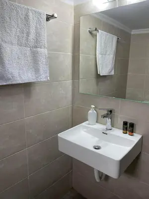 a bathroom with a white sink and a mirror at Chania Nice Apartment 3 in Chania Town