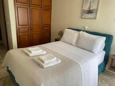 a bedroom with a bed with two towels on it at Chania Nice Apartment 3 in Chania Town