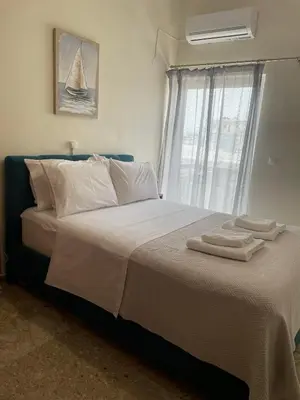 a bedroom with a large bed with towels on it at Chania Nice Apartment 3 in Chania Town