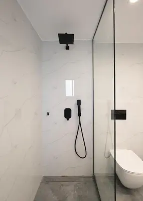 a bathroom with a toilet and a glass shower stall at Hermes&Dione in Argoulidhés