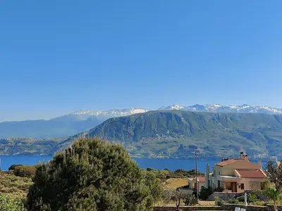a house with a view of a lake and mountains at Hermes&Dione in Argoulidhés