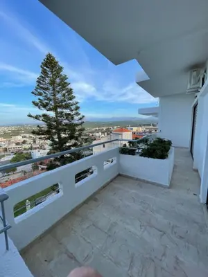 a balcony with a view of a city at Aeolos Apartments Kolymbari in Kolymvari