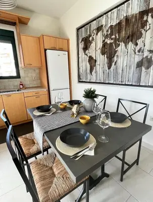 a dining room with a black table and chairs at Zoi’s Apartment in Chania Town