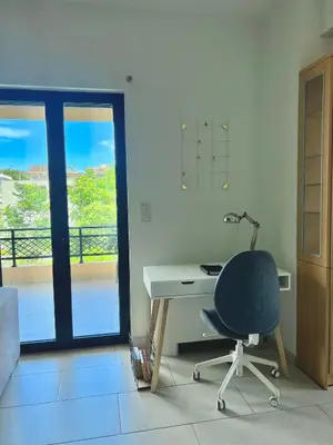 a desk and a chair in a room with a window at Zoi’s Apartment in Chania Town