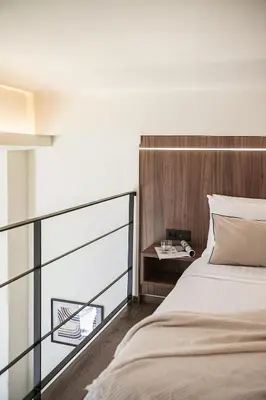 a bedroom with a large bed and a table at Copal Experience The Port in Chania Town