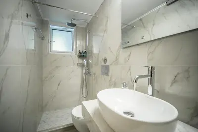 a white bathroom with a sink and a toilet at The Nest of Urban Living by 8essentially in Chania Town