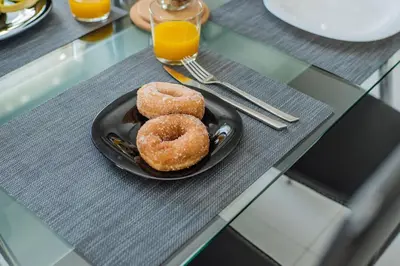 two donuts on a plate on a table at The Nest of Urban Living by 8essentially in Chania Town