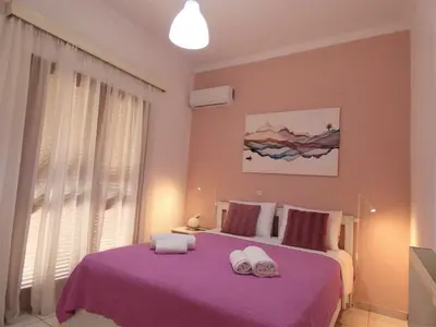 a bedroom with a purple bed with towels on it at Mel Studio 1 (kalamaki) in Kalamaki Chanion