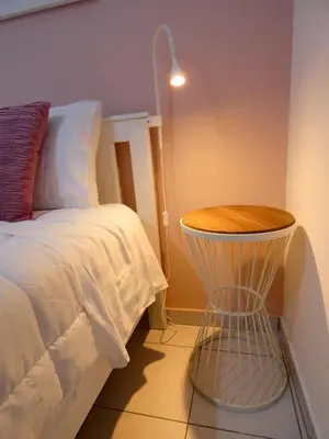 a bedroom with a bed and a table with a lamp at Mel Studio 1 (kalamaki) in Kalamaki Chanion