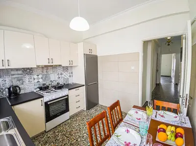 a kitchen with a table and chairs and a dining room at Fully renovated apartment close to the bus station and the city center! in Chania Town