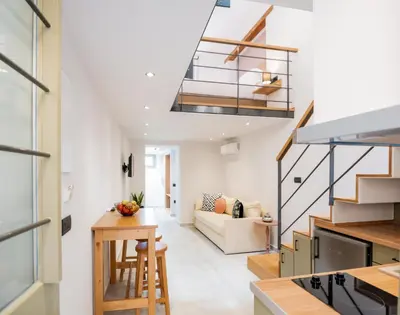 a kitchen and living room with a staircase in a house at Nem Home, amazing 1 bedroom house in Chania Town