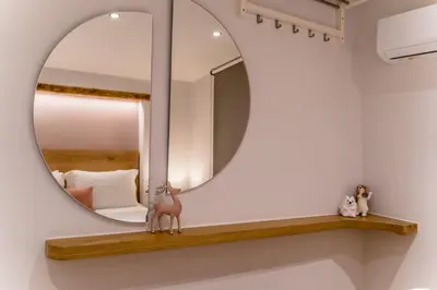 a mirror on a wall next to a bedroom at Nem Home, amazing 1 bedroom house in Chania Town