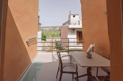 a balcony with a table and chairs and a view at Nem Home, amazing 1 bedroom house in Chania Town