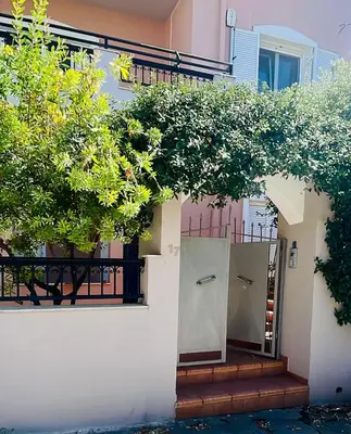a house with a staircase leading up to the front door at Mersini Apartment in Chania Town