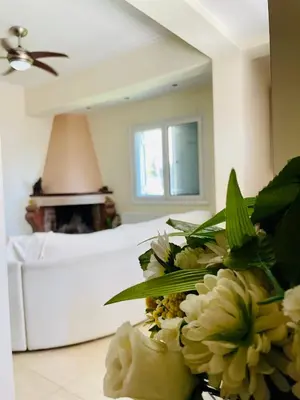 a bedroom with a bed and a bouquet of flowers at Mersini Apartment in Chania Town