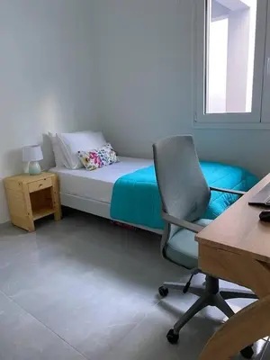 a bedroom with a bed with a chair and a desk at Villa Panorama Modi, with pool and stunning views in Chania Town