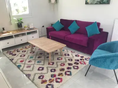a living room with a purple couch and a rug at Villa Panorama Modi, with pool and stunning views in Chania Town