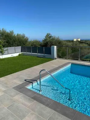 a small swimming pool on a patio at Villa Panorama Modi, with pool and stunning views in Chania Town