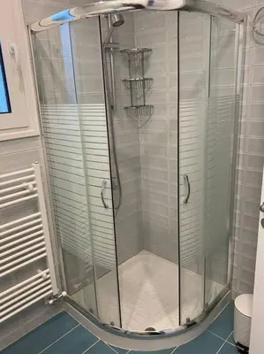 a shower with a glass door in a bathroom at Villa Panorama Modi, with pool and stunning views in Chania Town