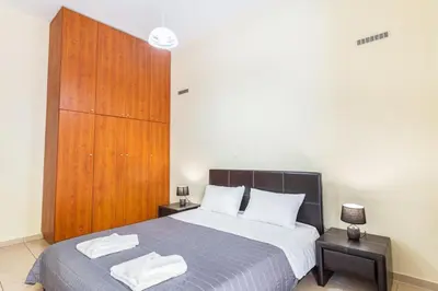 a bedroom with a bed with two towels on it at Neva's House in Chania in Chania Town