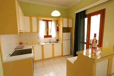 a kitchen with yellow cabinets and white appliances at Mel Studio 2 (kalamaki) in Kalamaki Chanion