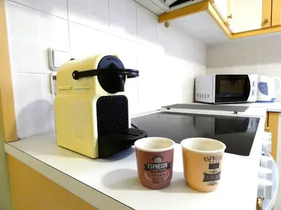 a coffee maker and two cups on a kitchen counter at Mel Studio 2 (kalamaki) in Kalamaki Chanion