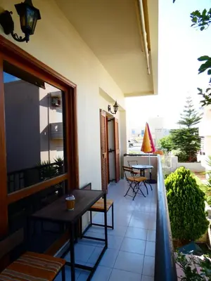 a patio with a table and chairs on a balcony at Mel Studio 2 (kalamaki) in Kalamaki Chanion