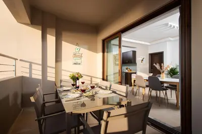 a dining room and living room with a table and chairs at Overview Chania with sea view and amazing sunset in Chania Town