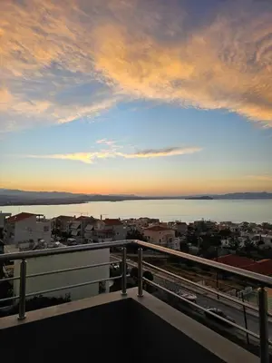 a view of the ocean from a balcony at Overview Chania with sea view and amazing sunset in Chania Town