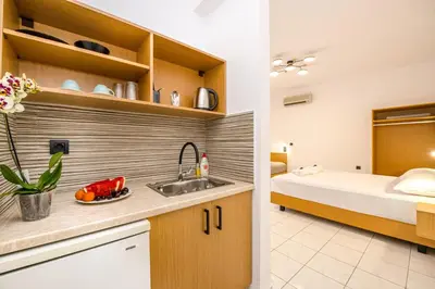 a kitchen and a bedroom with a bed and a sink at SMAROULA in Elafonisi