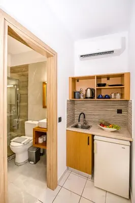 a bathroom with a sink and a toilet at SMAROULA in Elafonisi