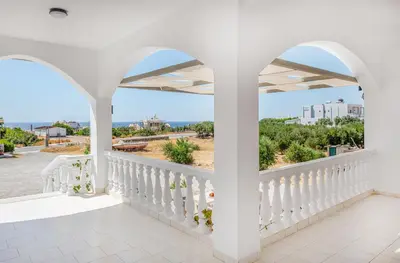 a white balcony with a view of the ocean at SMAROULA in Elafonisi