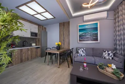 a living room with a couch and a table at Rena's luxury apartment with free private parking in Chania Town