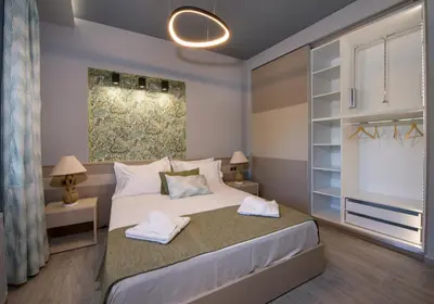 a bedroom with a bed with two towels on it at Rena's luxury apartment with free private parking in Chania Town