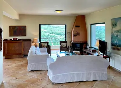 a living room with two couches and a tv at Olive Villa Plataniás in Xirokámbion