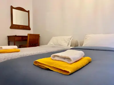 two beds with towels sitting on top of them at Aggelos and Thisbe Chania City Apartment in Chania Town