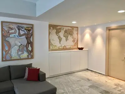 a living room with a couch and a map on the wall at Aggelos and Thisbe Chania City Apartment in Chania Town