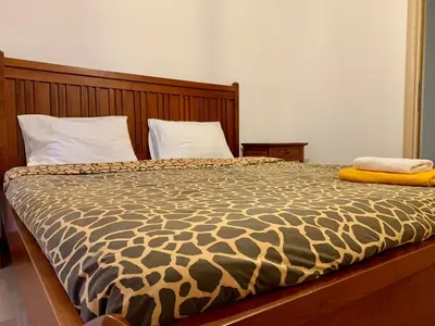 a bed with a brown and white comforter at Aggelos and Thisbe Chania City Apartment in Chania Town
